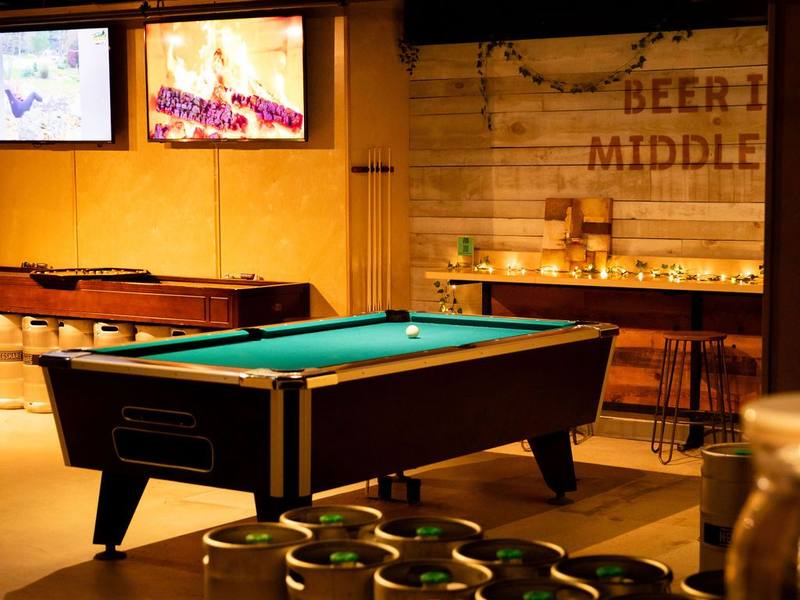 Pool table and lounge in the Ayr Village private lower level