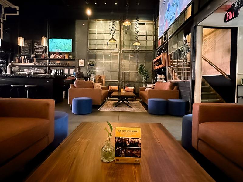 The lounge at Uptown Waterloo with sofas around a long wood table