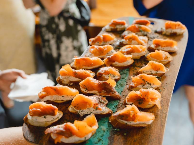 Smoked salmon canapés on a wooden board